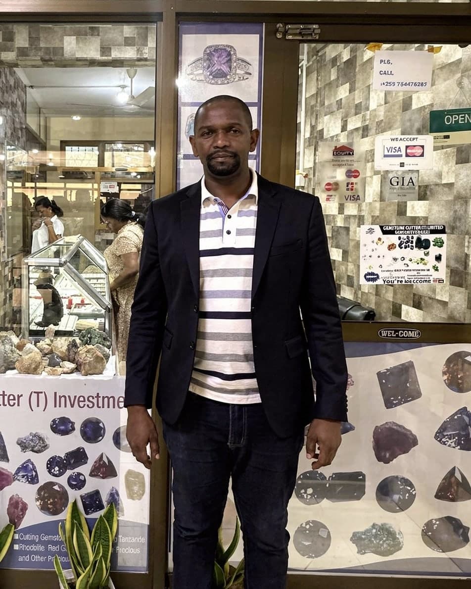 Mrema, owner of Gemstone Cutter (T) Investment, outside the shop in Kibo Tower